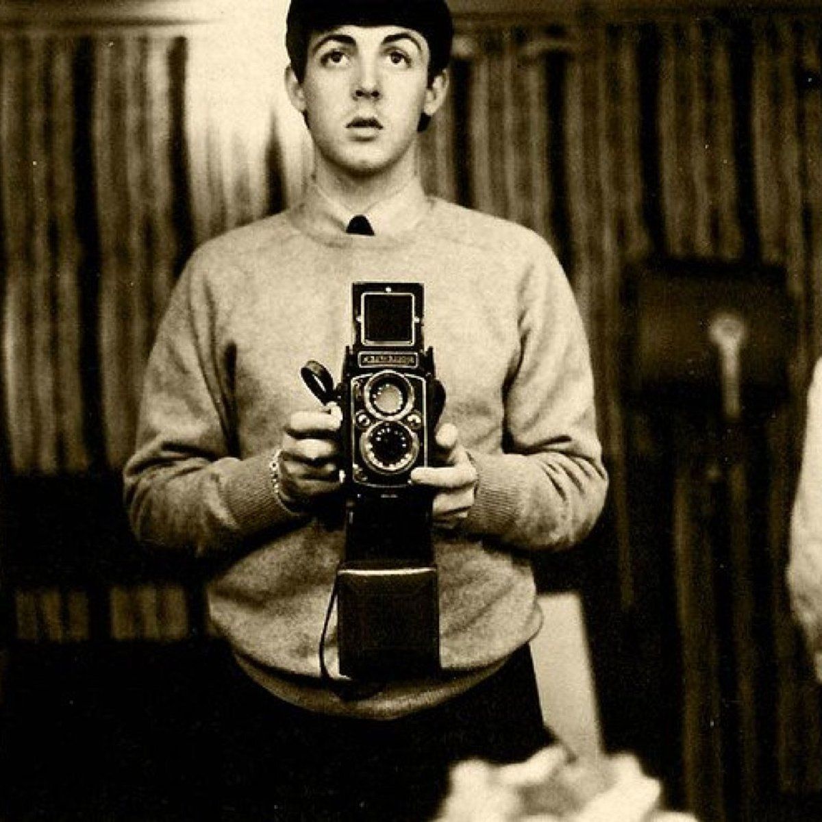 crockpics's tweet photo. Paul McCartney taking a moody mirror selfie with his 35mm Pentax camera in London, back in December 1963.

While this looks like just a casual snapshot, the backstory is fantastic—Paul actually took this photo himself! Back in late 1963, the guys in the band bought lightweight 35mm Asahi Pentax cameras so they could document their crazy lives from their own perspective. Paul ended up taking this particular mirror frame in his top-floor attic room at the Asher family home on Wimpole Street, where he was living with his girlfriend, Jane Asher.

That room is hallowed ground in pop history—it’s the exact space where Paul woke up a few months later with the melody to "Yesterday" completely formed in his head. You can see him looking straight into the lens here, catching a quiet, reflective moment of youth right before the Fab Four hopped across the Atlantic and changed music forever.