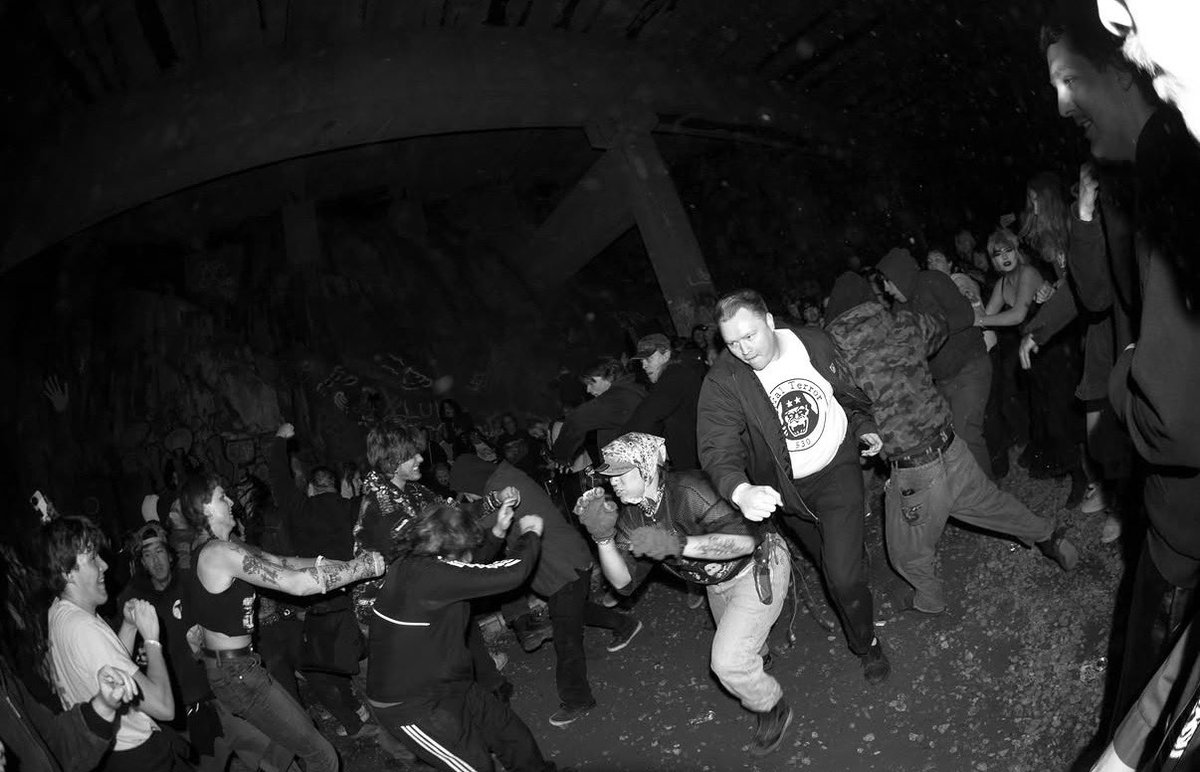 BobbyTheEmo's tweet photo. Hopping back on twitter for just a sec to share that my awesome local scene threw a generator show in an abandoned train tunnel in the mountains and it was completely insane. Here’s a pic I took paired with a pic someone took of me roughhousing with my friends :) https://t.co/vRyMHcMUv3
