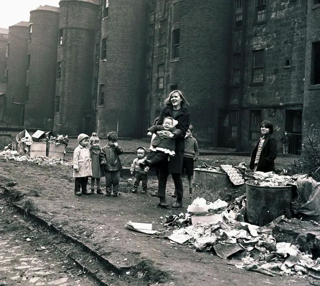 Dr_TheHistories's tweet photo. Youth worker playing with the children of the Gorbals, Glasgow, 1966. (Scotland)

The Gorbals district of Glasgow became one of the most famous examples of urban poverty in Britain during the 20th century. Originally developed in the 19th century to house industrial workers, many of its tenement buildings had fallen into severe disrepair by the 1950s and 1960s. Overcrowding, poor sanitation, and inadequate housing conditions contributed to high rates of illness and poverty, despite the strong sense of community that existed among residents.

By the mid-1960s, Glasgow Corporation had begun one of the largest urban renewal projects in Europe, demolishing thousands of tenement homes and relocating many residents to new housing estates and high-rise developments. Social workers and youth organizations played an important role during this transition, providing recreational programs, childcare support, and community services for families affected by the redevelopment.

The Gorbals later became a symbol of both the failures of industrial-era urban planning and the challenges of postwar public housing policy in Britain.

Between 1957 and 1977, Glasgow demolished more than 90,000 homes as part of its slum clearance program. At its peak, the city had one of the highest rates of overcrowded housing in Western Europe, with some Gorbals families living in single-room dwellings shared by multiple generations.

© History Pictures

#drthehistories