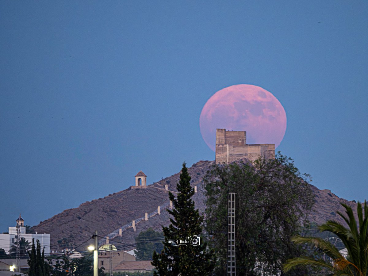 MeteOrihuela's tweet photo. ¡#FelizMartes! ¡De postal! Anoche (29/06/2026), #Luna llena tras el Castillo de Santa Bárbara o de Ayala, en #Cox (#Alicante). Al plenilunio del mes de junio se le conoce coloquialmente como #LunaDeFresa. Imagen: @JoseABarbera. https://t.co/97UrS9srIn