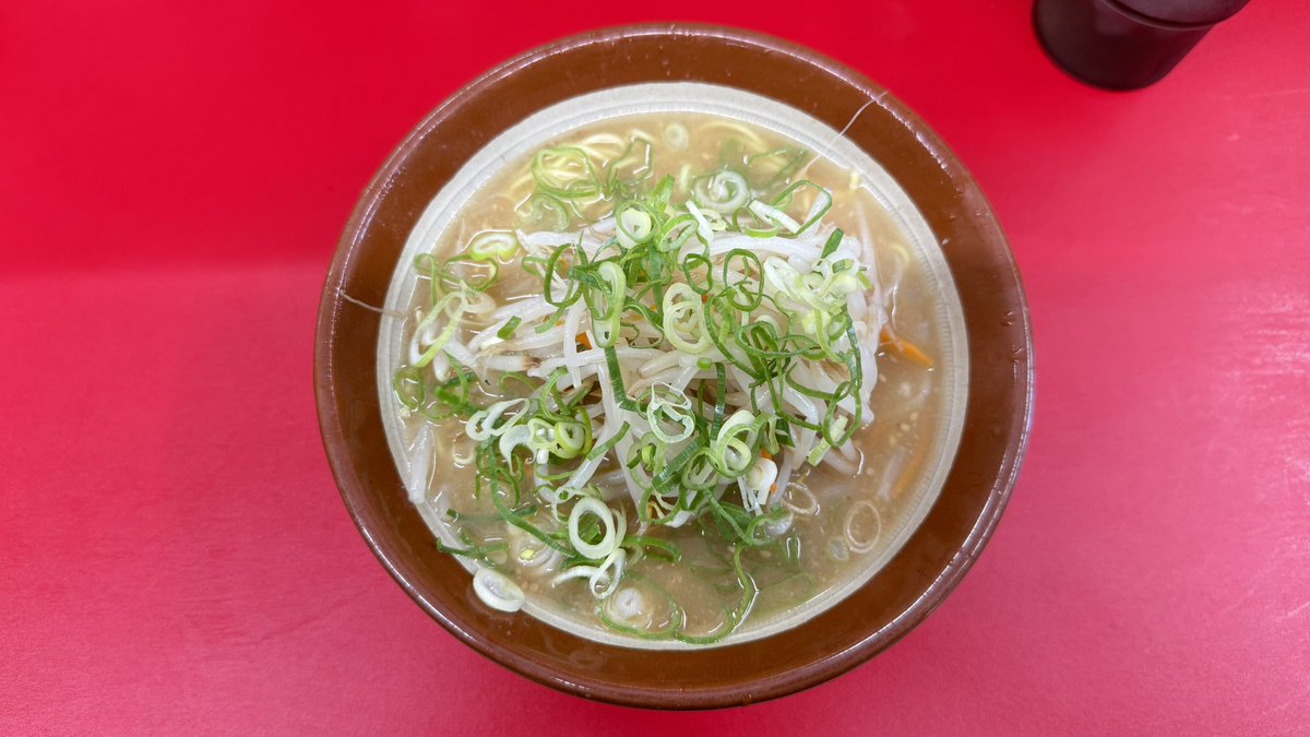 ogopoco26's tweet photo. 福岡県志免町「一楽ラーメン 志免店」
みそラーメン 950円

人気漫画「NARUTO -ナルト-」の作者が通っていたラーメン店として、つとに有名な「一楽ラーメン」

しかし「一楽ラーメン」の系譜を挙げて、と言われたら、福岡人でも、どこまで言えるだろうか？

名島本店
松島店
箱崎店
そして、志免店。

志免店は1987年に開店。現店主と両親で始めたそう。この両親のうち母親が、いまもお店にいるおばあちゃんで、松島店に詰めている創業者とは兄弟だそう（おばあちゃんに直接聞いた）。

なお「一楽ラーメン」出身で知られている店としては、名島本店にいた方が開いた「餃子 一鉄（福岡市中央区）」、津屋崎店の居抜きで継承した「まるにラーメン（福津市）」などがある。

さて、時刻は13時少し前。10人の行列が形成されていて、リニューアルしても変わらぬ人気を保っているようだ。

知ってのとおり、志免店の名物は「でかい唐揚げ」の定食。多くの客がそれを注文している。

なので、ちょっと時間かかるかな？と予想していると、驚くべきスピードで「みそラーメン」が提供された。

この早さは偶然ではない。

豚骨スープベースの「みそラーメン」 は、スープに味噌を溶かすタイプ。油はさほど感じず。野菜類は、丼に後乗せする手法をとっている。チャーシューはなし。麺は芯に硬さを残した食感だ。

わざわざ鍋で煽ったり、野菜を炒めたりしない。スピード勝負の味噌ラーメンだ。

その反面、スープと野菜が明確に分離しており、一体感という点ではやや疑問が残る。

店内の客を見渡せば、味噌ではなく、素直に「ラーメン」を頼む者が多い。

うむ、みんな、よく分かってるな。

「ー楽ラーメン 志免店」を楽しみたいなら、迷う必要はない。

唐揚げ定食。あるいは、ラーメン。いや、やっぱ唐揚げ定食一択かな。

※右下の唐揚げは、6年前に食べたものです