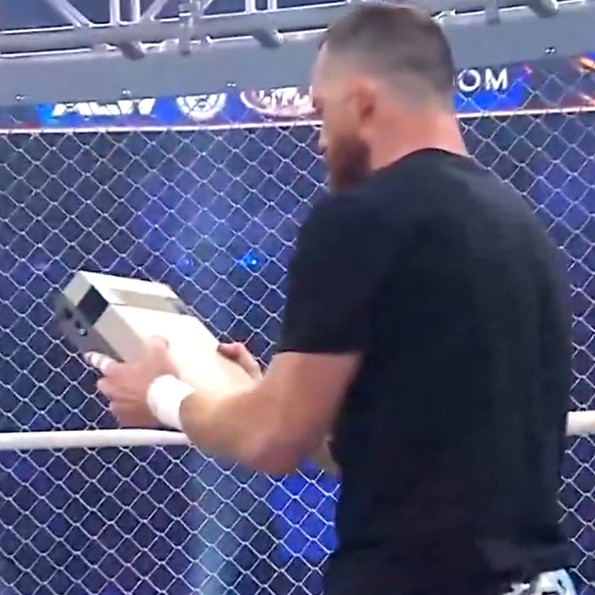 Dexerto's tweet photo. Wrestler Kyle O'Reilly pulled an NES out during an AEW cage match and used the console, controllers, and even a game cartridge as weapons

He blew into the cartridge before smashing it over his opponent's head https://t.co/Y49kMDVS5U