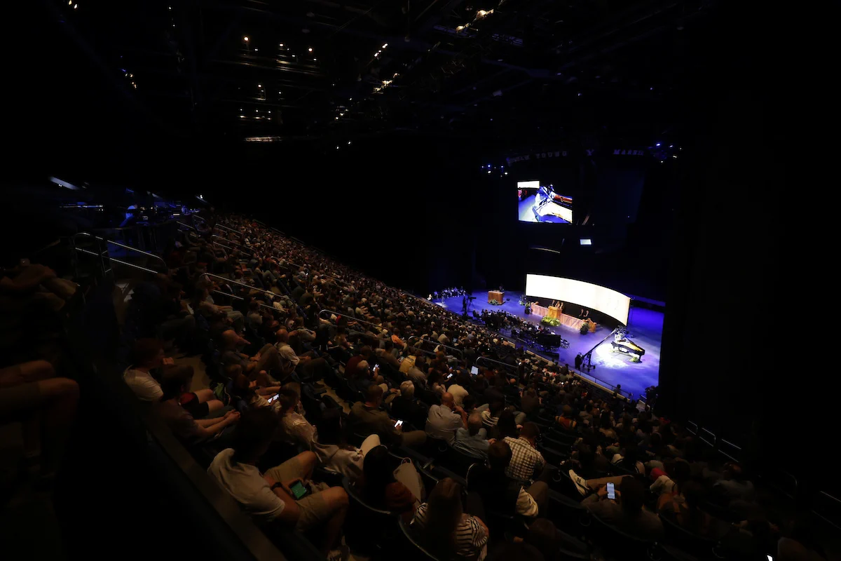 A view of an audience at the Marriott Center, devotional at the center