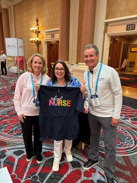 schoolhealth's tweet photo. School nurses, did you snag a free t-shirt at our booth last night?! Tag us below with a photo of you wearing it for the chance to win a ZOLL AED! #NASN2026 🫶 https://t.co/sde7nBc0TL