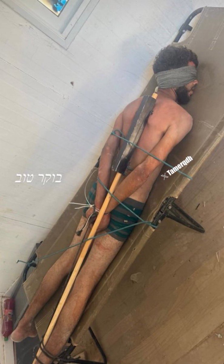 TheSaviour's tweet photo. 🚨🇮🇱🇵🇸The "most moral army" kidnapped an unarmed Palestinian man from northern Gaza, blindfolded him, and tied his hands and feet to a stretcher with a long stick and ropes.

Source: @tamerqdh https://t.co/iVvlKZYnBo