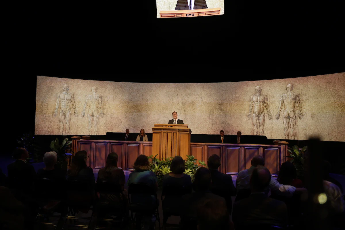 Anton E. Bowden speaks at a podium at BYU Devotional, June 2026.