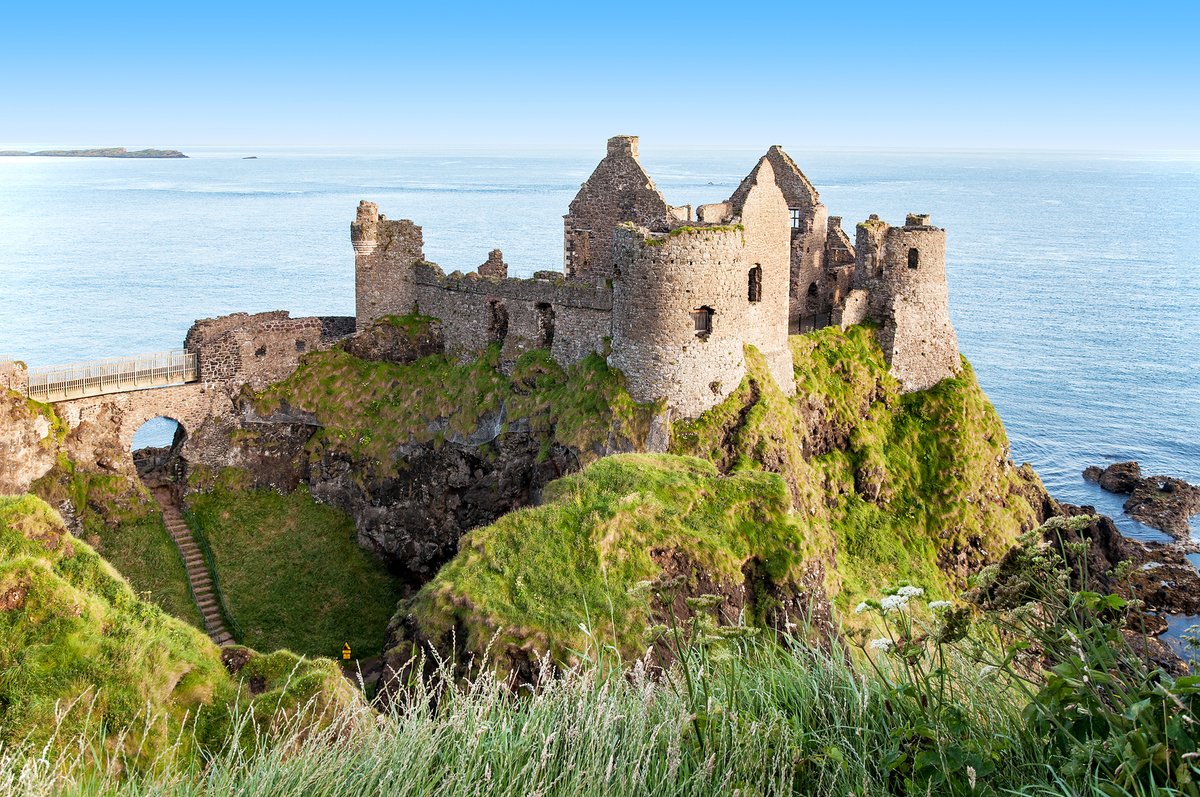 AnytimeTravel_'s tweet photo. Dunluce Castle sits right on the edge of a cliff on Northern Ireland's Antrim coast — close enough that, as the legend goes, the kitchen once tumbled into the sea during a 1639 storm, taking the servants with it. Historians think the story's more folklore than fact, but... https://t.co/BfmhTijzOk