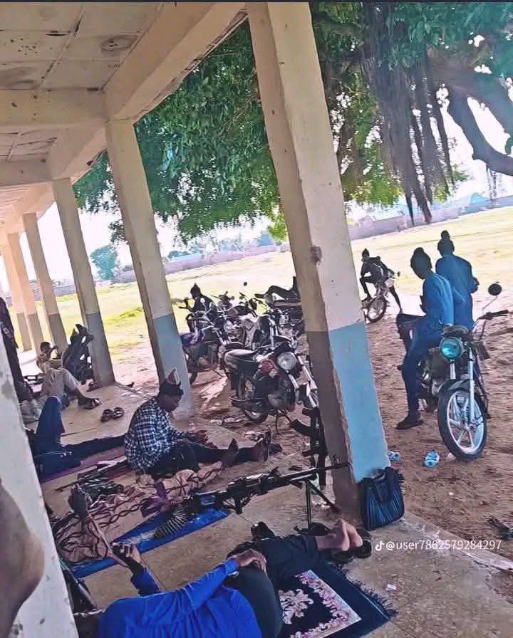 DEngliishalhaji's tweet photo. These are bandits sheltering around what appears to be a government-owned school. It's heartbreaking to see how insecurity has reduced communities to this. If cameras were placed here for the world to see, the reality on the ground would speak louder than any political debate. Yet, whenever people raise these concerns, some are quick to dismiss them as politics instead of acknowledging the suffering. The picture clearly shows that the community has lost so much: people have been displaced from their homes, children have been denied the education they deserve, and families have been pushed deeper into poverty. These are not just statistics; they are people's lives. May Almighty Allah bring peace to Nigeria, protect innocent civilians, and grant relief to everyone affected🙏