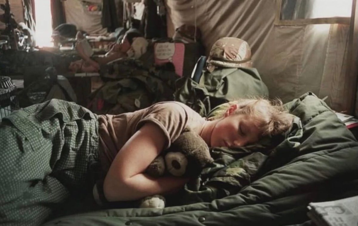 historyinmemes's tweet photo. Exhausted U.S. Army nurse Amy Stuart of the 5th MASH unit in Saudi Arabia sleeps on a cot while clutching a teddy bear sent by her family during Operation Desert Storm. The touching photograph, taken in February 1991, captures a rare moment of comfort amid the relentless demands of war.

Military nurses during Operation Desert Storm endured long, exhausting shifts as they treated combat wounds, traumatic injuries, and medical emergencies, often while living in harsh, temporary camps far from home. The 5th MASH (Mobile Army Surgical Hospital) was built to operate close to the front lines, allowing critically wounded soldiers to receive life-saving surgery and emergency care as quickly as possible.

This photograph reveals a side of war that is rarely seen. Beyond the tanks, aircraft, and battlefield tactics were nurses, doctors, medics, and support personnel working under relentless pressure with little opportunity to rest. A simple cot, a nearby helmet, and a teddy bear sent from home capture a deeply human moment of exhaustion, homesickness, and the emotional burden carried by those responsible for caring for the wounded.

Operation Desert Storm began in January 1991 following Iraq’s invasion of Kuwait the previous year. Although the coalition’s air campaign and ground offensive advanced rapidly, medical teams remained on constant alert, prepared to respond to mass casualties at any moment. For nurses like Amy Stuart, even a brief nap was a rare and valuable chance to recover.

In the years after the war, the U.S. Army gradually retired its MASH units, replacing them with more modern Combat Support Hospitals that offered greater mobility, flexibility, and advanced battlefield medical capabilities.