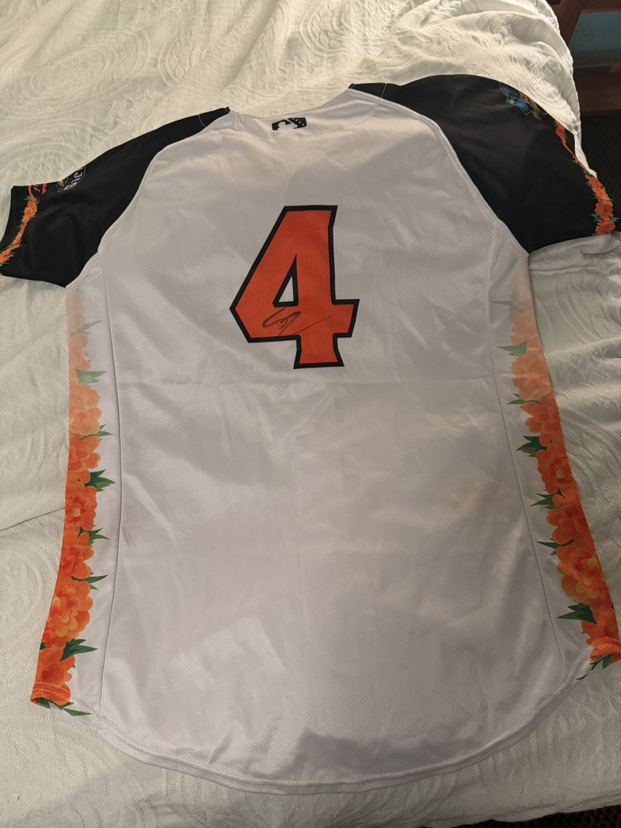 the_markcast's tweet photo. Popped on a game-used/signed Colt Emerson jersey for my 40th birthday and finally opened it tonight. 

It’s a Modesto Nuts “Alebrijes” theme night jersey. 

Truly a 1/1.

Exciting times for the #Mariners, our new long-term franchise infielder, and (hopefully) myself entering 40! 🤪

@Mariners 
@Colt_emerson