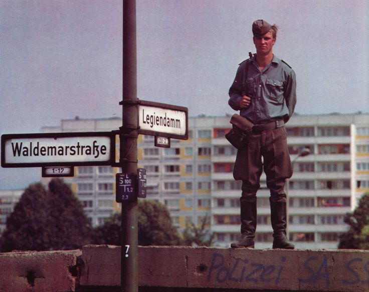 GDRvisuals's tweet photo. East German border guard standing on a section of the Berlin Wall, 1970s. https://t.co/S4Lr7Tnnqc