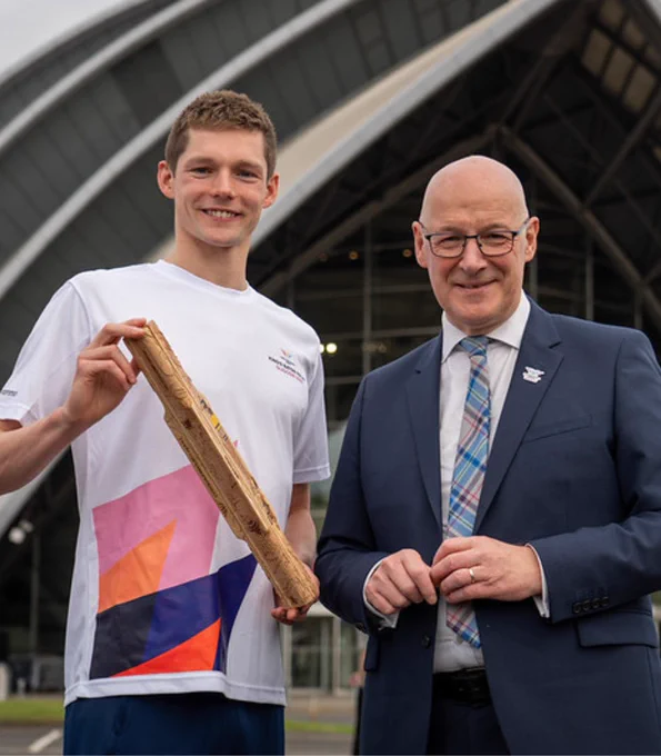 First Minister John Swinney and swimmer Duncan Scott, who is holding the King's Baton, outside the OVO Hydro, Glasgow.