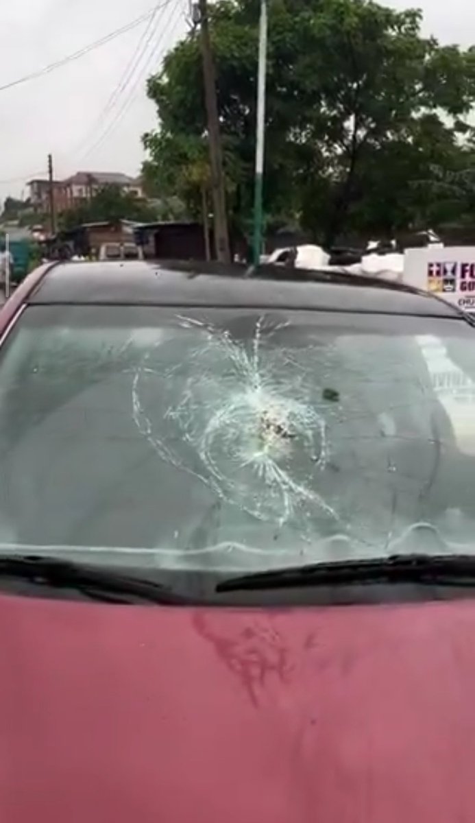 creative_yua's tweet photo. This lady broke the windshield of another man's car just because she was angry with her own boyfriend.

As I could deduce, her man had probably broken up with her, moved to another area, and got a new girlfriend. So, this lady traced him to the new place and came with full anger.

She kept behaving like something was wrong  with her in the head, as she was shouting, rolling in the gutter, and fighting everyone around there.

Due to the commotion, one of her boyfriend's friends decided to drive the guy away from the place.

That was when she picked up a huge stone and smashed it against the car's windscreen.

Presently, the lady has been handed over to the police.

Now this makes me wonder:

What would make a lady run "mad" like this over a man? A lady who's not even married to the man for that matter?

Many people are seriously mahdd in this country.