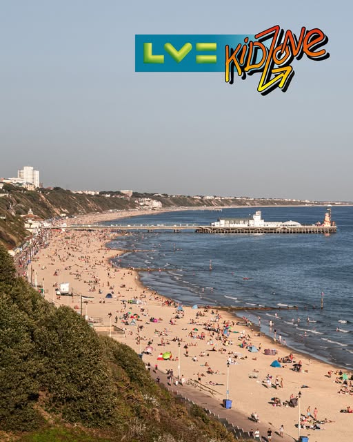 A busy beach scene with numerous people sunbathing and enjoying the sea. In the background, Bournemouth pier stretches into the water. The logo for LV KidZone is in the top right.
