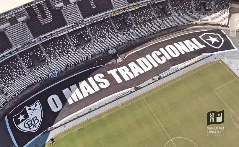 MovNacag's tweet photo. DESDE 1894

Quando Armando Albano, saudoso atleta do Botafogo Football Club, veio a falecer na sede do Mourisco Mar, dois homens tomaram talvez a maior decisão da história do Botafogo.

Augusto Frederico Schmidt, presidente do Club de Regatas Botafogo, e Eduardo Góis Trindade, presidente do Botafogo Football Club, protagonizaram um dos maiores símbolos de humildade e união que este clube já viu. Diante daquela tragédia, fizeram a pergunta que mudaria nossa história para sempre:

"O que mais é preciso para que os nossos dois clubes sejam um só?"

Desde então, nossa história passa a ter como marco inicial o dia 1º de julho de 1894. Nascemos na Praia de Botafogo, remando. E temos muito orgulho disso.

Mais do que o orgulho de sermos o clube poliesportivo relevante mais antigo do país, que esta data também seja sempre um momento de reflexão.

Schmidt e Eduardo abriram mão de suas vaidades e de seus projetos. Em meio à dor, entenderam que um Botafogo verdadeiramente unido seria muito mais forte.

Até meados de 2015 e 2016, porém, era incomum ver uma valorização do verdadeiro ano de fundação do Botafogo. Nosso centenário, por exemplo, foi comemorado em 2004, e não em 1994, como historicamente deveria ter sido.

Inconformados com isso, desde o primeiro coletivo que construímos, começamos a colocar 1894 em absolutamente tudo. Surgiram a Iniciativa Botafogo 1894, a Comissão de Festas 1894, o lendário estandarte escrito 1894 através dos Loucos Pelo Botafogo, diversas faixas com os dizeres "Desde 1894" e o maior bandeirão da história da nossa arquibancada, sempre com o mesmo padrão, o escudo do Club de Regatas à esquerda e o após fusão à direita. Até o apelido "O Mais Tradicional" ganha ainda mais sentido quando se compreende que o Botafogo é o clube poliesportivo mais antigo do país. 

Também é justo reconhecer o quanto a coleção de uniformes de 2019, especialmente a histórica camisa preta com o escudo do Club de Regatas, ajudou a popularizar essa visão da nossa história.

Somos o Botafogo de Futebol e Regatas.

Nascidos em 1894 para remar. E, depois, para transformar o Brasil no país do futebol.

📷 Luisa Portella e Vitor Silva