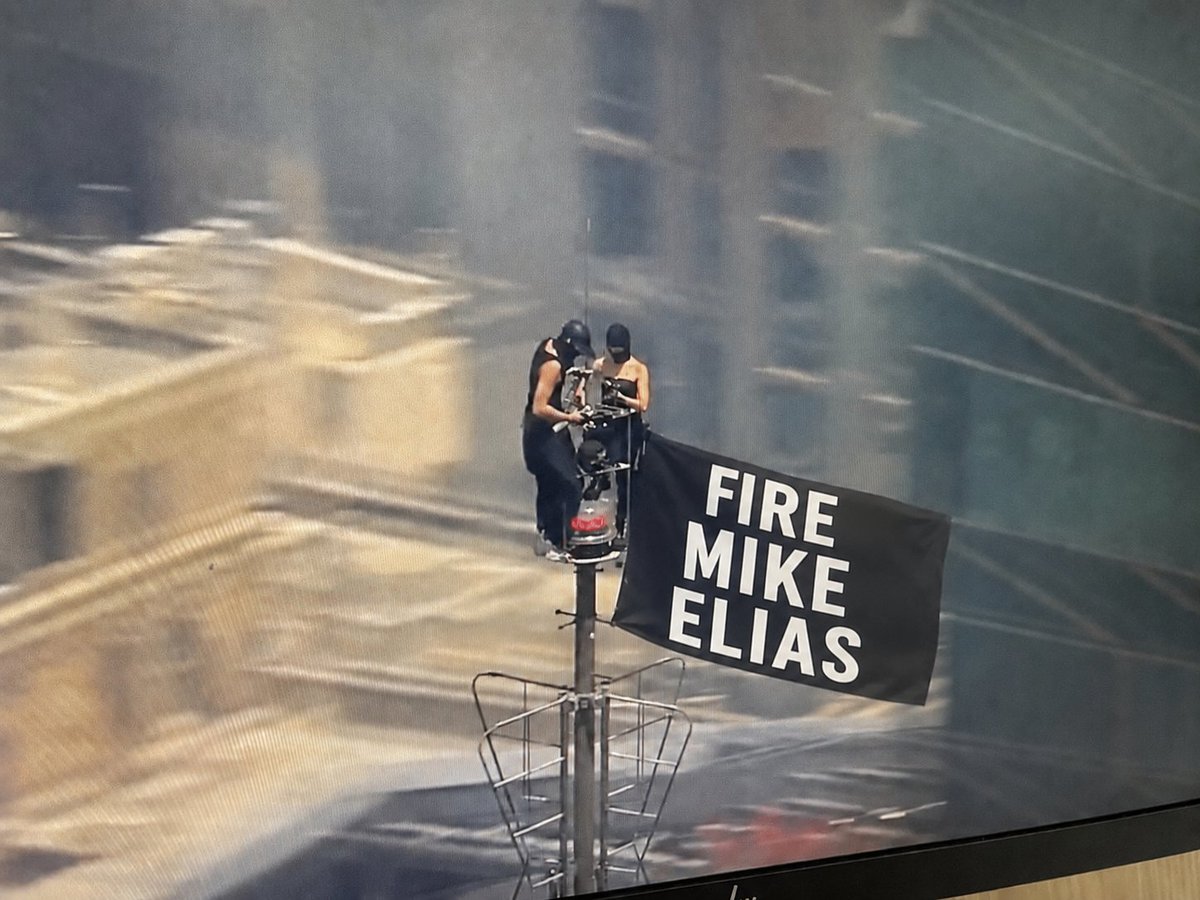 relishdaddy's tweet photo. Two people on top of the Empire State Building with a banner... https://t.co/16pUEtdKwr