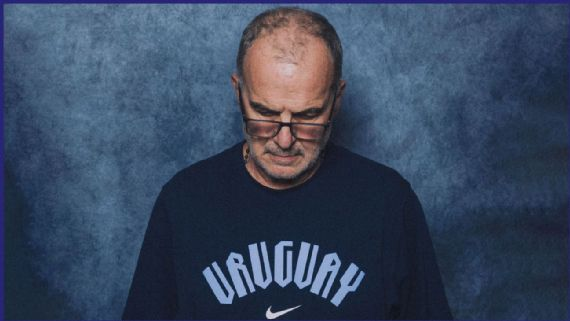 altieribruno's tweet photo. MARCELO BIELSA, EXTRANJERO DE SÍ MISMO

Solo sé que no sé nada. La frase de Sócrates, bien podría aplicar a Marcelo Bielsa en su conferencia de prensa post eliminación del Mundial 2026. Bien podría aplicar también, por qué no, a todos nosotros, humildes mortales, que debatimos en una mesa de café, que oficiamos de fiscales, que acostumbramos a levantar la voz hacia jueces imaginarios acerca de si el entrenador argentino es inocente o culpable. Ángel o demonio. Genio o loco. Víctima o victimario.

Nada de eso importa demasiado.

Mersault, el protagonista de 'El Extranjero' de Albert Camus, nos eriza la piel en un pasaje de esa obra maestra cuando asegura ser "extranjero de sí mismo". Ahí va Bielsa, con su imperfección tan perfecta, debatiéndose entre excesivamente cuerdo o alienado. Podrás amarlo, podrás odiarlo, pero jamás podrás ser indiferente a él.

Marcelo Bielsa sufre, a sus 70 años, un conflicto de época. Se declara tóxico. Se martiriza, se carga de culpas, se atormenta. Sufre. Es un azote tras otro en un vía crucis emocional que duele de solo verlo a miles de kilómetros de distancia. Mira hacia abajo, explica que no es un modelo publicitario, que es un entrenador de fútbol. Se esmera en tratar de explicar lo inexplicable.

Las eliminaciones tempraneras con Argentina en 2002 y con Uruguay en 2026 provocan el escarmiento general. Bielsa, en situaciones de presión, se equivoca. Bielsa se peleó con Luis Suárez. Bielsa creyó en Fernando Muslera. Bielsa sacó a Federico Valverde a los 60 minutos del segundo tiempo. Bielsa, los jugadores, la época. Los fantasmas del pasado. Los desafíos del presente. Su conferencia de prensa. El dolor de ya no ser. El dolor, más agudo, de ya no pertenecer.

No a un Mundial. A un modelo. A un contexto. A una época. A un mundo en el que Bielsa enseñaba, con precisión quirúrgica, con docencia de maestro rural, intramuros. Un entrenador de jugadores, un formador de personas, que hace hueco en el profesionalismo extremo de hoy. Que le cuestan los grupos. Hubo tiempos en los que no se necesitaba tanto impacto, ni declaraciones estrambóticas para poder ser. No había anzuelos para confundir inocentes. Se escuchaba más de lo que se decía. Se leía más de lo que se veía. Se aprendía más de lo que se gritaba.

Bielsa explica, a su manera, que lo suyo ya es pasado. No sus capacidades, no sus habilidades. Sus mensajes son contraculturales para la era de las redes sociales. "Explíqueme la revolución rusa en 45 segundos". "Cómo ser ingeniero químico en un mes y medio". "Hágase rico en cuatro meses: descubra las bondades de la física cuántica en cursos online de 45 minutos semanales". El modo express del planeta. La desesperación de esperar. La sensación ilógica de construir la Sagrada Familia de Antonio Gaudí mirando reels de Instagram. Bielsa dice, como puede, tratando de no faltar el respeto, lo mismo que vivimos aquellos que ya peinamos algunas canas: los jugadores no toleran videos largos de más de diez minutos. Dice que no quieren, pero más duro aún, que no lo aguantan. Entonces lo que debería demorar tiempo, tiene que ser inmediato. ¿Dónde queda, como decía Alejandro Dolina, la aventura del conocimiento y el aprendizaje?

"Todo tiene su costo y el que no quiere afrontarlo es un garronero de la vida. De manera que aquel que no se sienta con ánimo de vivir la maravillosa aventura de aprender, es mejor que no aprenda. Yo propongo a todos los amantes sinceros del conocimiento, el establecimiento de cursos prolongadísimos, con anuncios en todos los periódicos y en las estaciones del subterráneo. "Aprenda a tocar la flauta en 100 años". "Aprenda a vivir durante toda la vida". "Aprenda. No le prometemos nada, ni el éxito, ni la felicidad, ni el dinero. Ni siquiera la sabiduría. Tan solo los deliciosos sobresaltos del aprendizaje" - Alejandro Dolina.

Bielsa escupe, a borbotones, como puede, con las herramientas y la energía que le queda, el sentimiento de confusión de quien se levanta por la noche y lo han mudado de casa. Ni siquiera eso: lo han mudado de barrio. De ciudad. Y por qué no de país. Se habla otro idioma, las costumbres son otras, y lo que alguna vez era ya no es.

"Todo lo que yo sé no es mucho ni poco. Todo lo que yo sé lo volqué a cualquier persona, organización o profesional que me pidió durante estos tres años. Tengo la absoluta certeza que a nadie le importa lo que yo sé. Todo lo que yo quise transmitir nunca fue importante, a ningún nivel. Eso desde mi punto de vista no me parece importante, solo digo que a los demás no les importa aprender" - Marcelo Bielsa.

El mundo que alguna vez conoció Marcelo Bielsa ya no existe. El Mundial tiene 48 selecciones. Hay pausas de hidratación cada cuarto de hora. El negocio del fútbol, que ya era grande, ahora es inmenso. Él forma parte de ese núcleo, sus contratos así lo indican, pero sus herramientas ya no tienen el poder que alguna vez tuvieron.

La conferencia de prensa de Uruguay, con un Bielsa auténtico, la de un hombre que mira de frente, que no esquiva los errores, que abraza los fracasos, es un grito de ayuda. Es un aullido de una generación ya olvidada. Una despedida. No de Uruguay. Es un adiós a lo más profundo que tiene una persona: la sensación profunda, cabal, angustiante, de ya no pertenecer.

El mundo ha vivido equivocado. Extranjero de sí mismo.

Y todo lo demás, también.