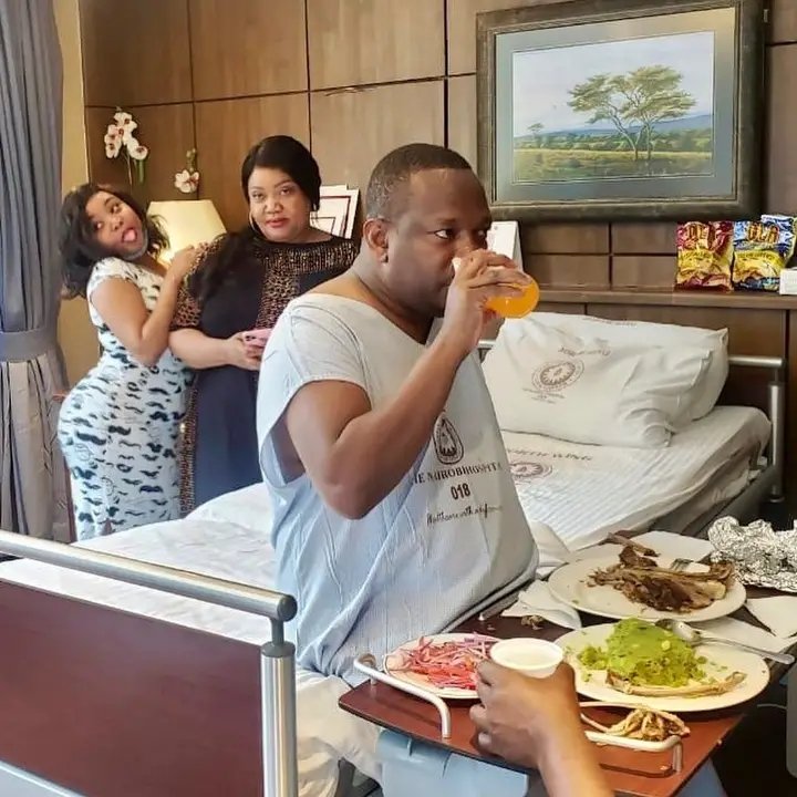 ivymuthe's tweet photo. This photo of Mike Sonko in hospital, while his daughter Thicky Sandra is pausing for a photo with her mum behind him, is goated https://t.co/9BohCl7vYH
