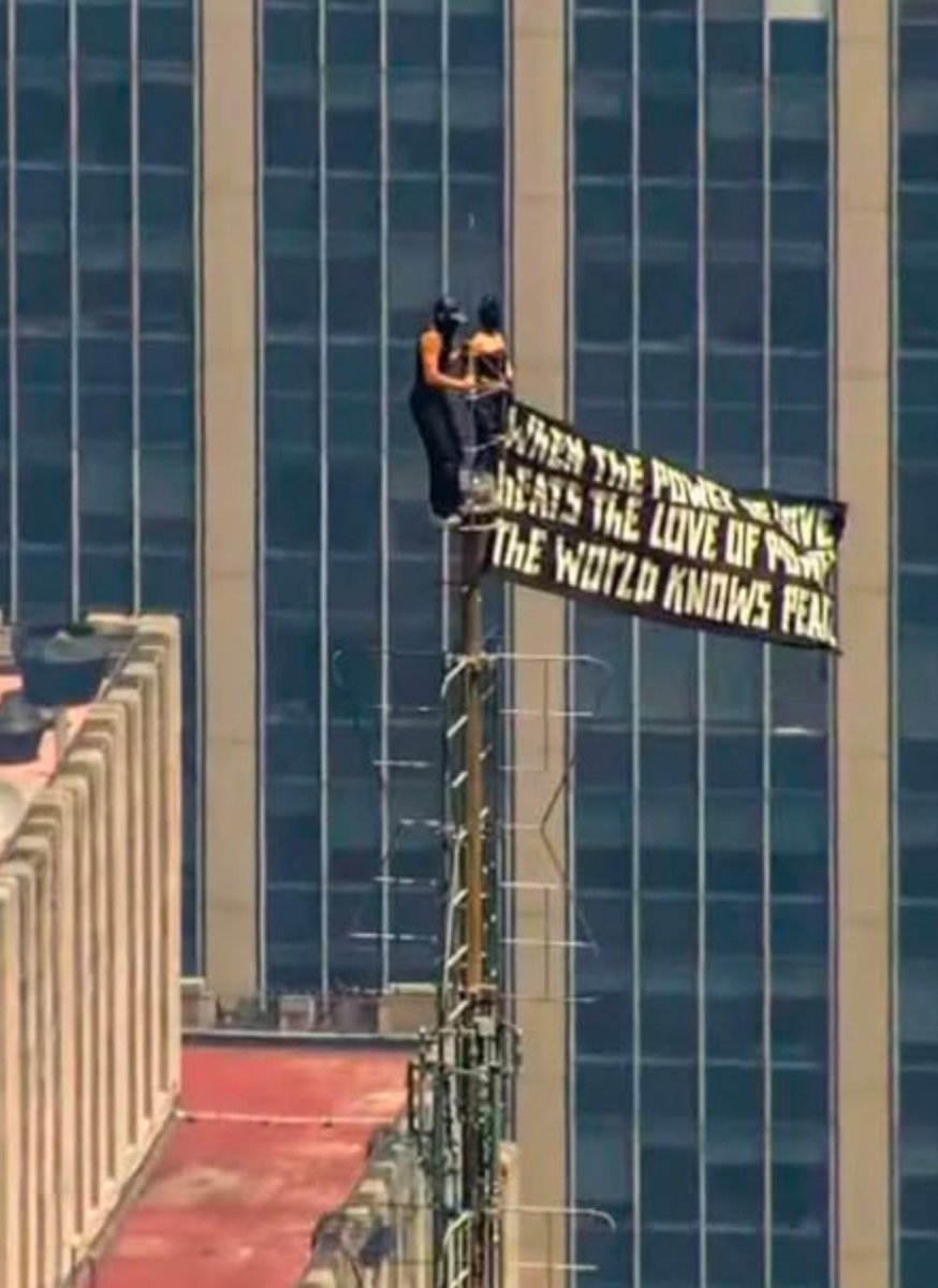 AzPetrich's tweet photo. Hold up! Not only did they climb to the tippy top of the Empire State Building to attach a protest banner that read: 

"When the power of love beats the love of power, the world will know peace." 

They got engaged while doing it!

And the woman was wearing a batman mask! ❤️ https://t.co/zafGPxXYX9