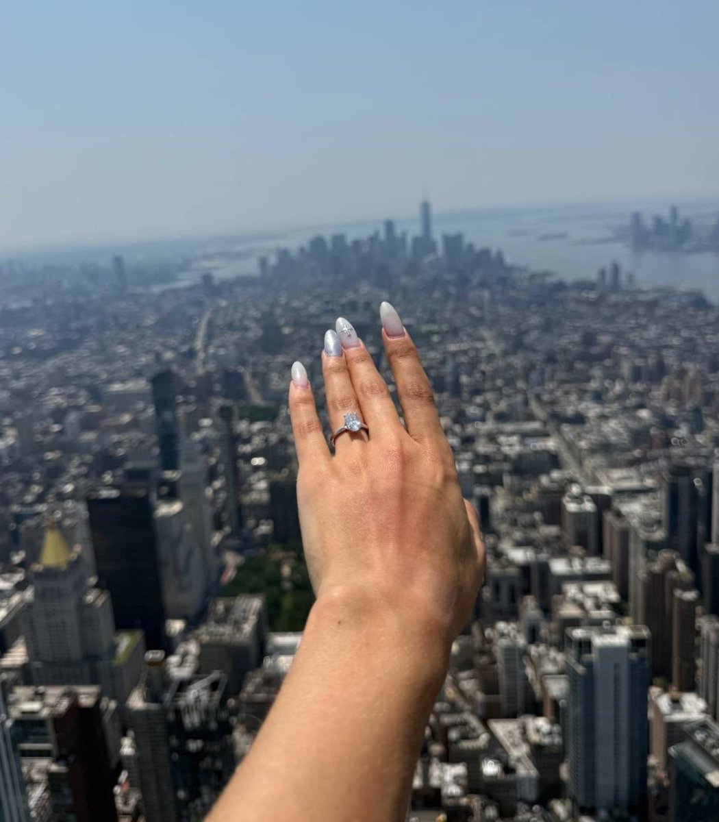 pubity's tweet photo. Angela Nikolau showed off her engagement ring after her boyfriend proposed to her atop the Empire State building.

They were both arrested a short time later for illegally climbing the building. https://t.co/kySzpWlg6Z