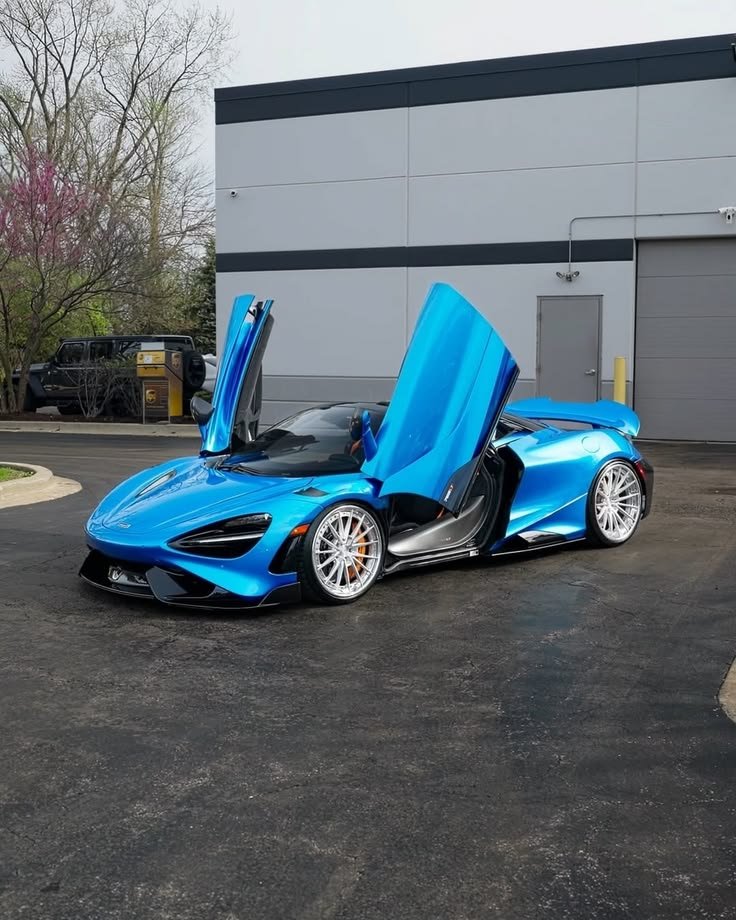 rah0623's tweet photo. Parked like this, with those doors up, it’s not a car; it’s a spacecraft ready to launch. 🚀💙 https://t.co/JV3pEUBgJf