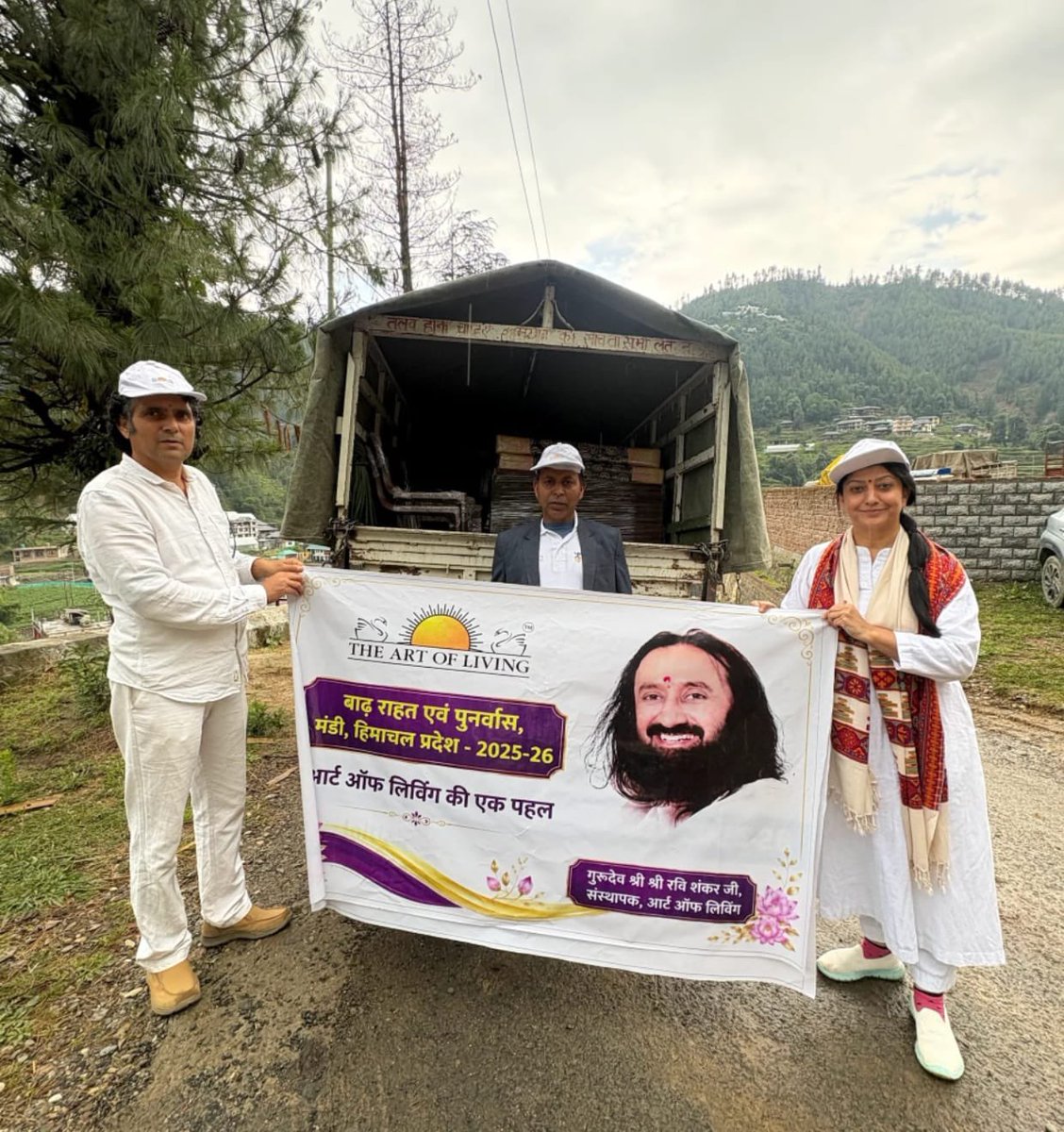 ArtofLiving's tweet photo. In one of the biggest disaster of the year 2025, flood-hit Seraj region of Himachal Pradesh, The Art of Living and IAHV reached thousands of people providing solace and support during this disaster.

The Art of Living volunteers carried the relief & rehabilitation drive for disaster-hit families in various regions of Mandi & Kullu.

Since July last year, ₹ 20 lakh worth of relief material has reached 275 families across both districts.

The Art of Living reached thousands of people in more than 30 villages of Thunag and Chachyot tehsil in the Mandi district that were inaccessible due to multiple cloud bursts and landslides. People were relieved of the trauma through Pranayam and Meditation. 
Essential materials for rehabilitation were provided to 25 families in these tehsils. 

The support included storage beds, mattresses, pillows cupboards, tables, chairs, and other household necessities, helping families rebuild their lives with dignity and hope.

The distribution was conducted in the presence of SDM Sanjeet Sharma, Thunag and DFO Surender Kashyap.

@Gurudev
@IAHVOfficial @ArtOfLivingHP
@InfinityAol @CMOFFICEHP @SukhuSukhvinder @jairamthakurbjp @KanganaTeam @dcmandi