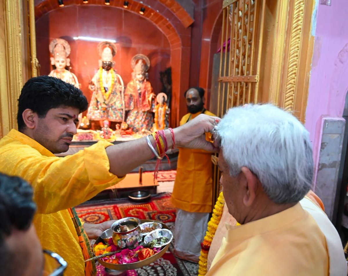 ANB_JK's tweet photo. Lieutenant Governor Manoj Sinha on Thursday paid obeisance at the ancient Shri Ram Mandir in Purani Mandi, Jammu, and offered prayers for the happiness, well-being and prosperity of all. During his visit, he conveyed his heartfelt best wishes to the Sadhus and Sadhvis embarking on the annual Shri Amarnath Ji Yatra. Mahamandleshwar Mahant Rameshwar Dass, MLAs Yudhvir Sethi and Kuldeep Raj Dubey, along with religious leaders and senior officials, accompanied the Lieutenant Governor.