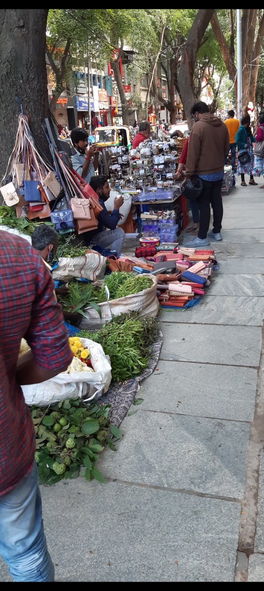 prapthi_m's tweet photo. The soul of Malleshwaram has been stolen. Sadists are celebrating the dismantling of a vibrant and thriving ecosystem. It is ugly classism dressed up as civic virtue and nothing else. The street vendors existed and thrived because they offered value for money and quality that isn't available in the stores.

Livelihoods have been wiped out today. And yet again, what will follow is indefinite harrassment, torture and corruption. It has been happening for years.

The first two pictures are mine, from one of my visits to Sampige Road. The last two pictures are how Sampige Road looks today (not my pictures).