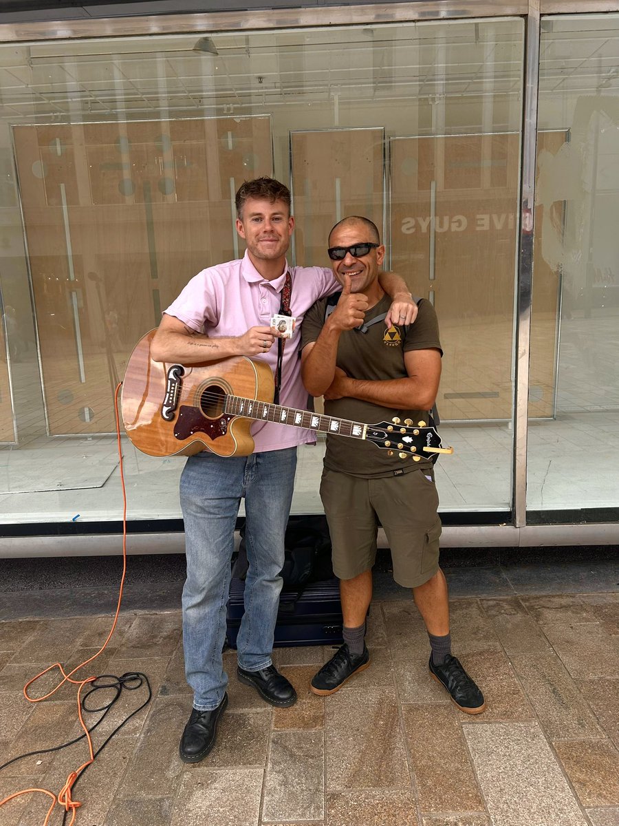 dazcadwallander's tweet photo. Met this absolute legend today (Stefano). Honestly, it’s people like this that keep the dream alive. I wasn’t feeling a million dollars this morning but dragged myself out to busk anyway, a few songs in he runs over, chucks me a tenner and says “mate I could feel your voice in my heart walking up The Moor, you’re like David Gray but better, how the fuck do you not have a record deal”. The words mean more than any amount of money, it’s no secret that a large part of the music industry for grassroots working class musicians like myself is on its arse. So when you’re out there busking your own songs to passes by it’s this sort of thing that fills you back up with belief and changes your whole day for the better. Cheers Stefano 🤝🧡