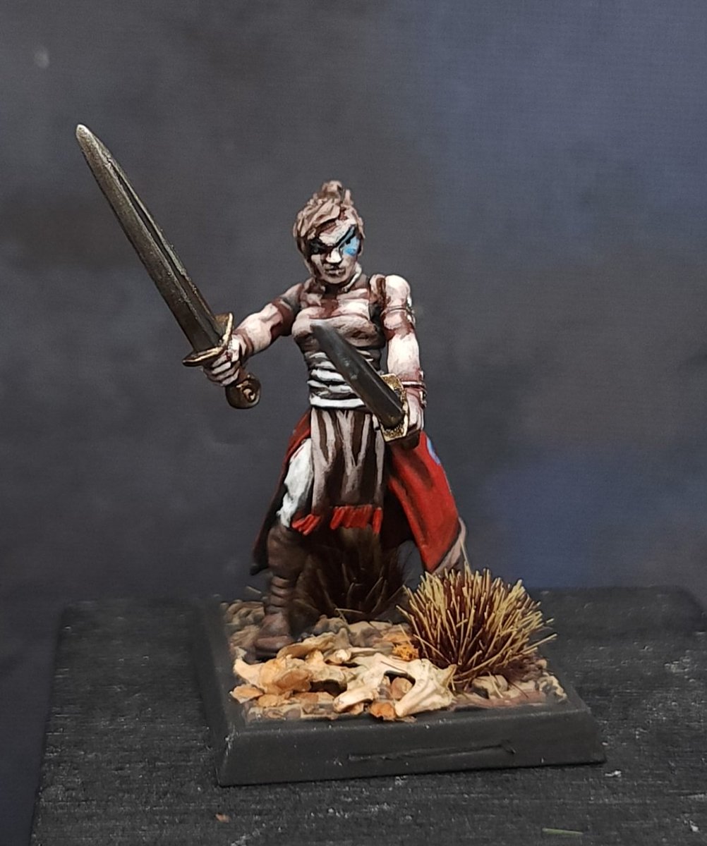 MidMiniGuy's tweet photo. Female Fighter from @reapermini. Sculpted by Werner Klocke. Went with a tanned skin &amp; a blue tattoo on her left eye, blue whorls on her red skirt. I thought of her as a bronze age fighter, so I gave her bronze swords instead of steel &amp; gold arm bands &amp; torc. https://t.co/EmD7rmQrY7
