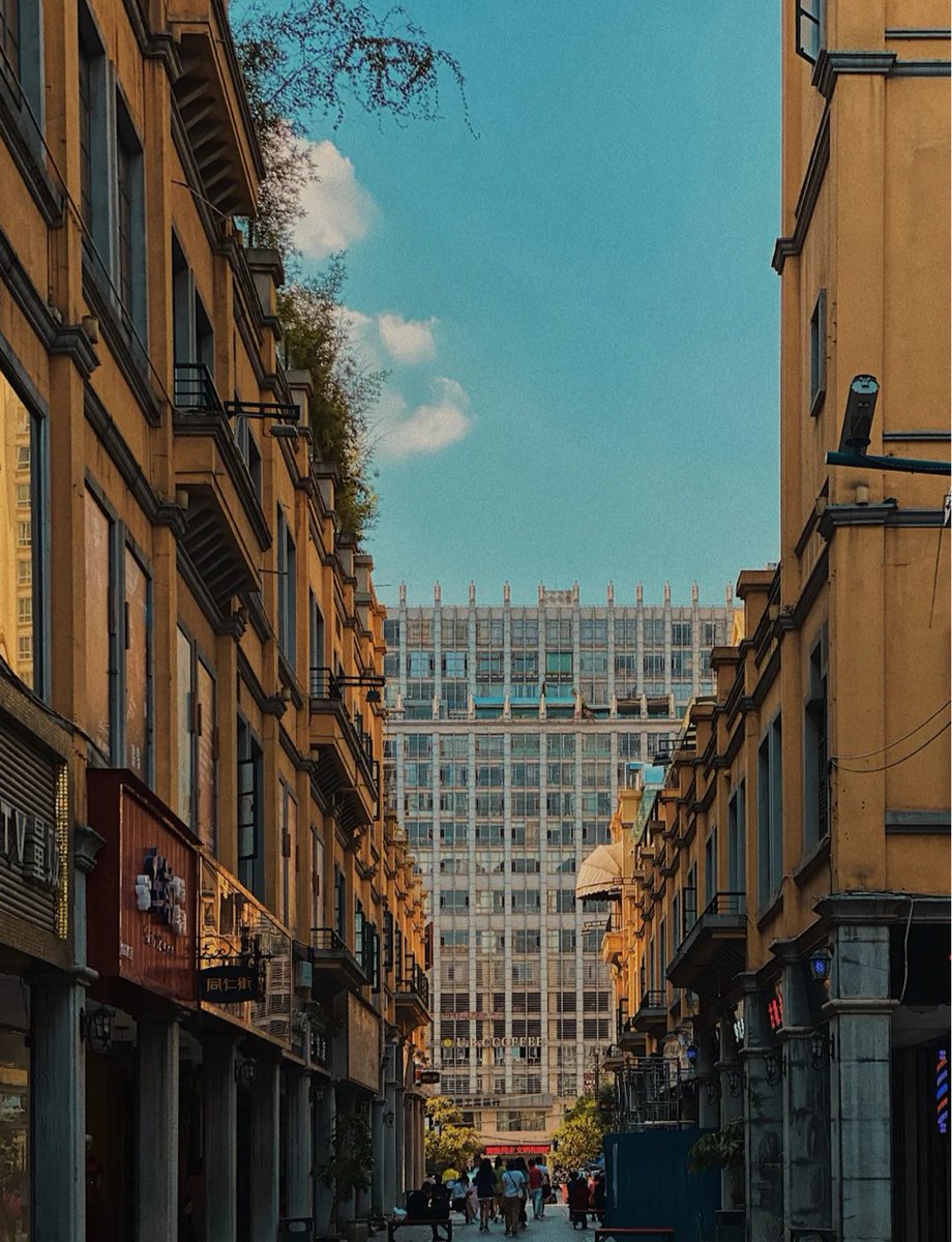 jokeson23's tweet photo. Just a random street snap that caught my eye—golden hour light hitting old storefronts like a hidden postcard. https://t.co/KgNDieVOOB