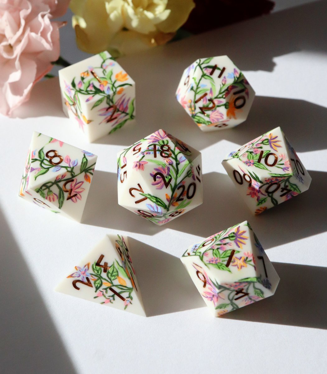 EVERYTHINGDICE's tweet photo. Let's meander through a path carved by charming fae... or deceptive foes? 🪻✨ Wildflora is back with a limited restock!

#dnd #dice #ttrpg https://t.co/Q5BXBuSeOH