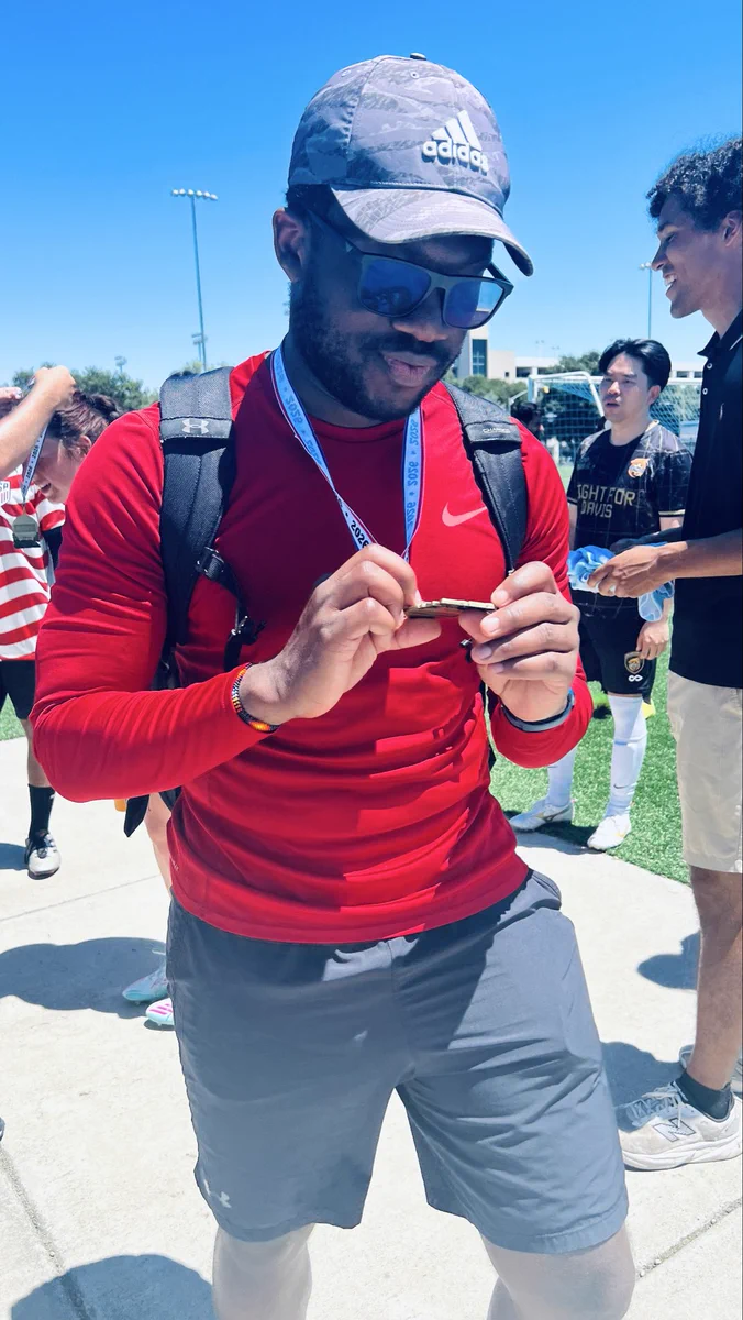 Grad student smiling and holding medal.