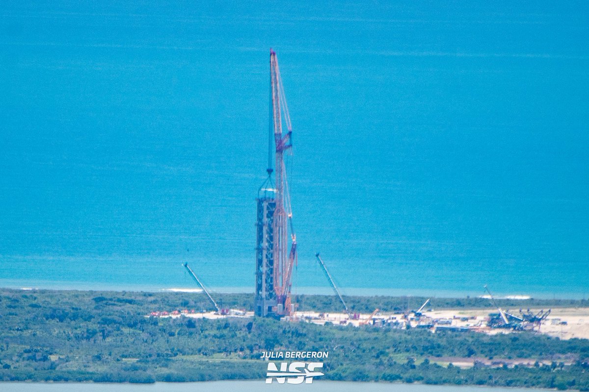 julia_bergeron's tweet photo. Next day update:

Whoa, we're half way there! Module four is now stacked on the 37A tower. 
🏗🏗🏗🏗

There are cranes a plenty over at LC-36 as Blue prepares to remove sections and modify the tower for potential launch later this year.

Tune into the @NASASpaceflight SCL feed for live views and stay tuned for more aerial views!
https://t.co/6KAhBCL7eM