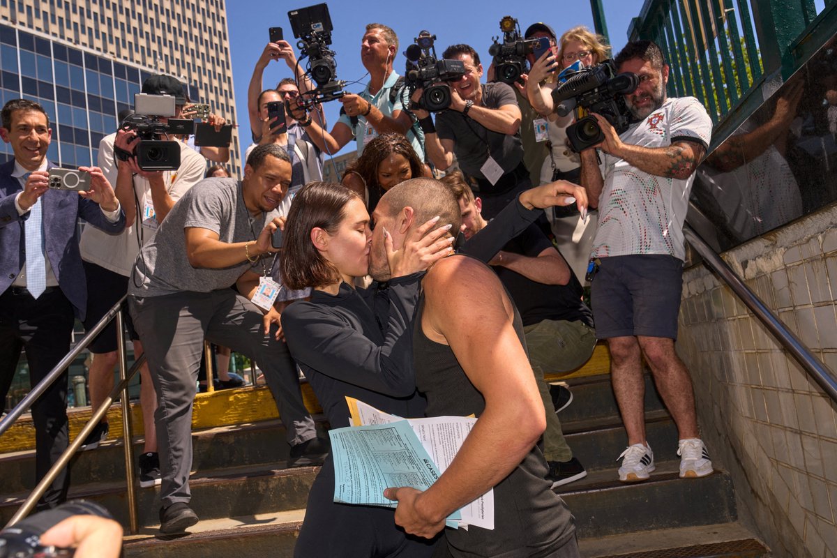 MeidasTouch's tweet photo. Angela Nikolau and Vanya "Ivan" Beerkus, the couple who climbed to the top of the Empire State Building spire, kiss at the Brooklyn Bridge-City Hall train station after exiting New York City Criminal Court after their arraignment, in the Manhattan Borough of New York, U.S., July 2, 2026. REUTERS/Bing Guan