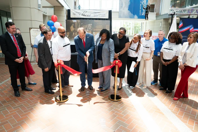 Photo of the "Step into Their Shoes" exhibit ribbon cutting ceremony.