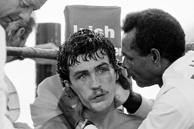 HistoricSports2's tweet photo. Chris Smith's amazing shot of an exhausted Barry McGuigan near the end of his title defeat to Steve Cruz in the searing Nevada desert in June 1986.  His vacant eyes say it all.  He lost the 15th and final round decisively and with it his featherweight crown https://t.co/3mFH8IrrTW