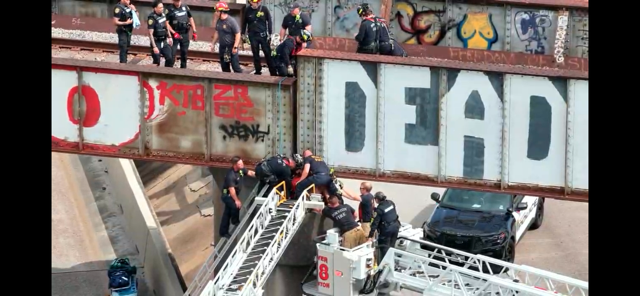 FirefightersHOU's tweet photo. Houston firefighters at work: A high-angle rescue at the Be Someone railroad overpass in downtown Houston. D08, E8, E1, L6,L19, HR11, SF30, AS30, A9, M9, RE42, L18 https://t.co/sFti7469g1