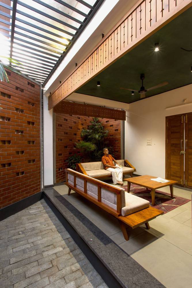 shavnyuyngah's tweet photo. Since we keep compromising cheap affordability for long term durability, we will keep falling off.

This house in Kerala is 1,520 square feet on an odd-shaped 11-cent plot and it has two courtyard sky courts, a double roof system, perforated brick walls facing west to catch wind and block harsh afternoon sun, and timber joinery throughout. The brick is not decorative. The perforations are calculated to manage airflow and solar gain on a single storey structure, which attracts more heat than multi-storey buildings. The double roof, a flat slab beneath and a truss roof stretched over the entire structure, creates an interspace that absorbs heat before it reaches the living spaces. Every material decision in this house is doing a specific job.

The courtyard is where family life actually happens. It is where the sound of rain is heard from inside the house, where children grow up, where people sit together without planning to. We have removed it from our homes entirely and replaced it with small verandas that face the road for the neighbours to see. We build for appearance and we build cheap, and then we wonder why nothing lasts and why our homes do not feel like homes.

A house is not four walls and a roof. The people living inside it are the whole point.

Eranellur, Kerala | Finder Studio | Photography: Prasanth Mohan