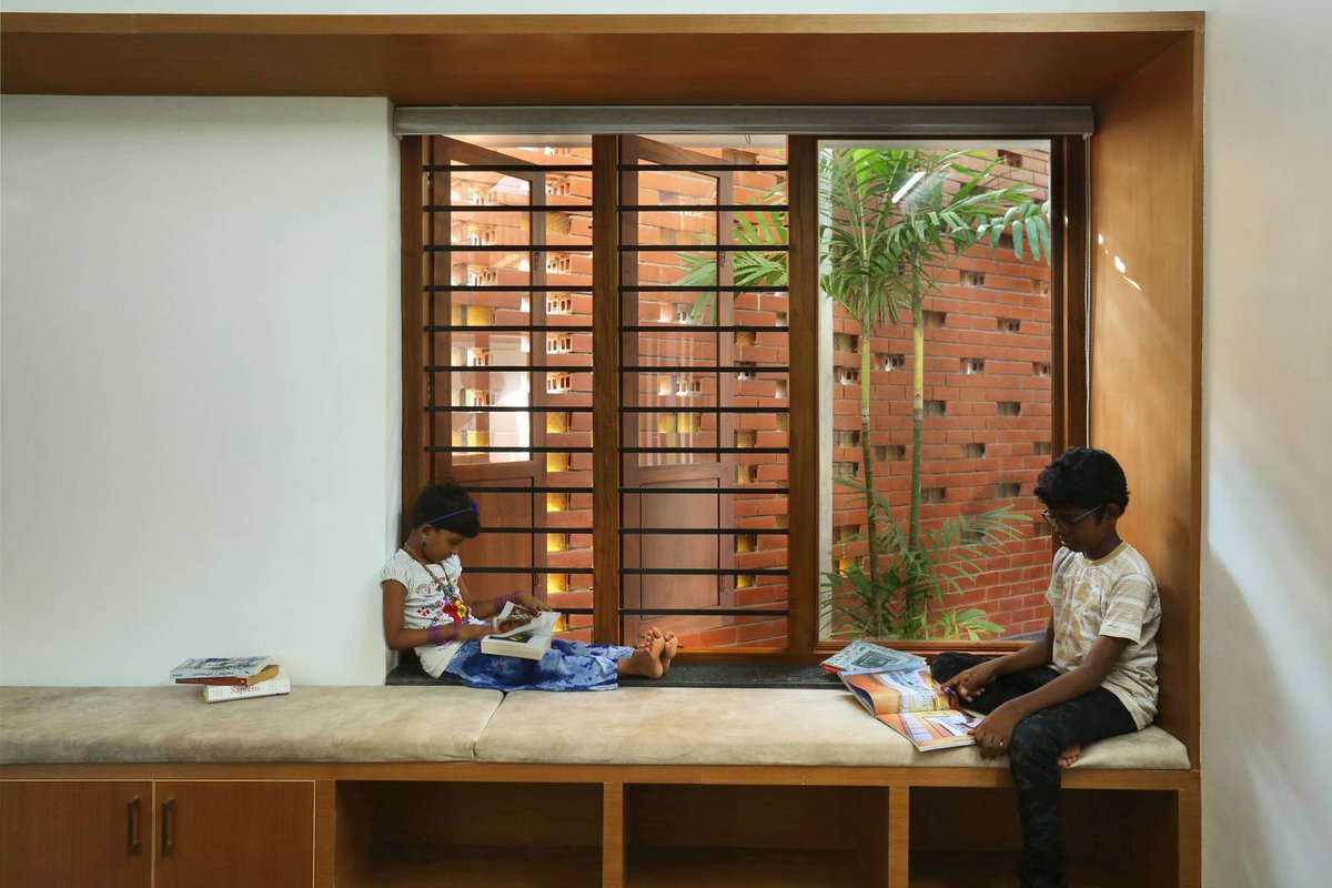 shavnyuyngah's tweet photo. Since we keep compromising cheap affordability for long term durability, we will keep falling off.

This house in Kerala is 1,520 square feet on an odd-shaped 11-cent plot and it has two courtyard sky courts, a double roof system, perforated brick walls facing west to catch wind and block harsh afternoon sun, and timber joinery throughout. The brick is not decorative. The perforations are calculated to manage airflow and solar gain on a single storey structure, which attracts more heat than multi-storey buildings. The double roof, a flat slab beneath and a truss roof stretched over the entire structure, creates an interspace that absorbs heat before it reaches the living spaces. Every material decision in this house is doing a specific job.

The courtyard is where family life actually happens. It is where the sound of rain is heard from inside the house, where children grow up, where people sit together without planning to. We have removed it from our homes entirely and replaced it with small verandas that face the road for the neighbours to see. We build for appearance and we build cheap, and then we wonder why nothing lasts and why our homes do not feel like homes.

A house is not four walls and a roof. The people living inside it are the whole point.

Eranellur, Kerala | Finder Studio | Photography: Prasanth Mohan