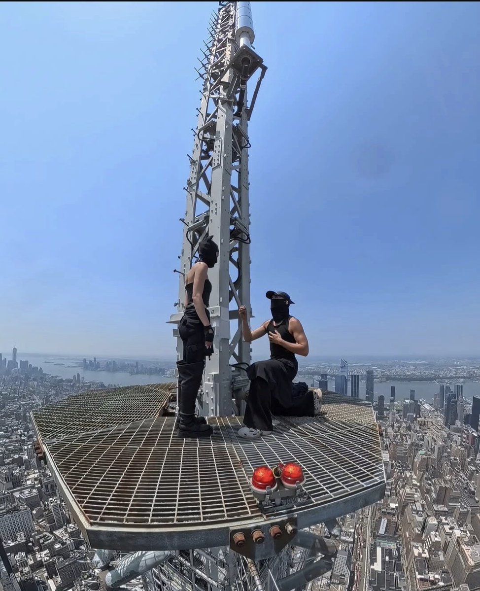 AzamNigre's tweet photo. THE COUPLE WHO CLIMBED THE Empire State Building... have been chasing heights for years.

Angela Nikolau and Ivan Beerkus were arrested after climbing the building's 1,454-foot antenna and unfurling a banner that read, "When the power of love beats the love of power, the world knows peace."

Before being taken into custody, Ivan appeared to propose on a lower platform. The pair are known worldwide for documenting extreme urban climbs and were featured in the Skywalkers: A Love Story.