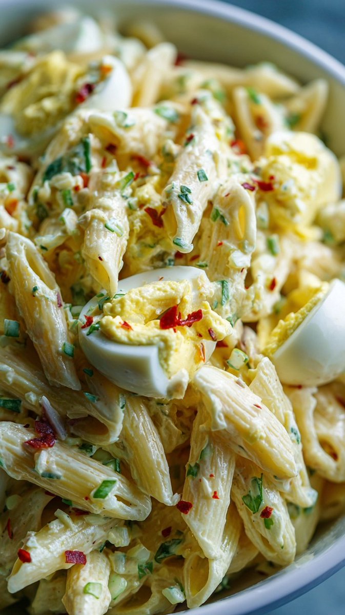 SpoonandSoul's tweet photo. Creamy Deviled Egg Pasta Salad 🍛🍛
"Comfort in every creamy bite"

 Ingredients
12 oz (340 g) penne pasta, cooked and cooled
6 hard-boiled eggs, chopped
¾ cup mayonnaise
2 tbsp Dijon mustard
1 tbsp yellow mustard
1 tbsp sweet pickle relish
1 tsp apple cider vinegar
½ tsp garlic powder
½ tsp onion powder
Salt and black pepper, to taste
2 tbsp fresh chives, chopped
2 tbsp celery, finely diced
¼ tsp crushed red pepper flakes 
Paprika, for garnish
 Instructions: 
Cook the pasta until al dente, then drain, rinse with cold water, and let cool completely.
In a large bowl, whisk together the mayonnaise, Dijon mustard, yellow mustard, relish, vinegar, garlic powder, onion powder, salt, and pepper until smooth.
Fold in the cooled pasta, chopped eggs, celery, and chives until evenly coated.
Sprinkle with crushed red pepper flakes if desired, and garnish with paprika and extra chives.
Chill for at least 30 minutes before serving for the best flavor.

Creamy, tangy, and packed with classic deviled egg flavor, this pasta salad is the perfect side dish for picnics, barbecues, potlucks, or a light summer lunch. 😋