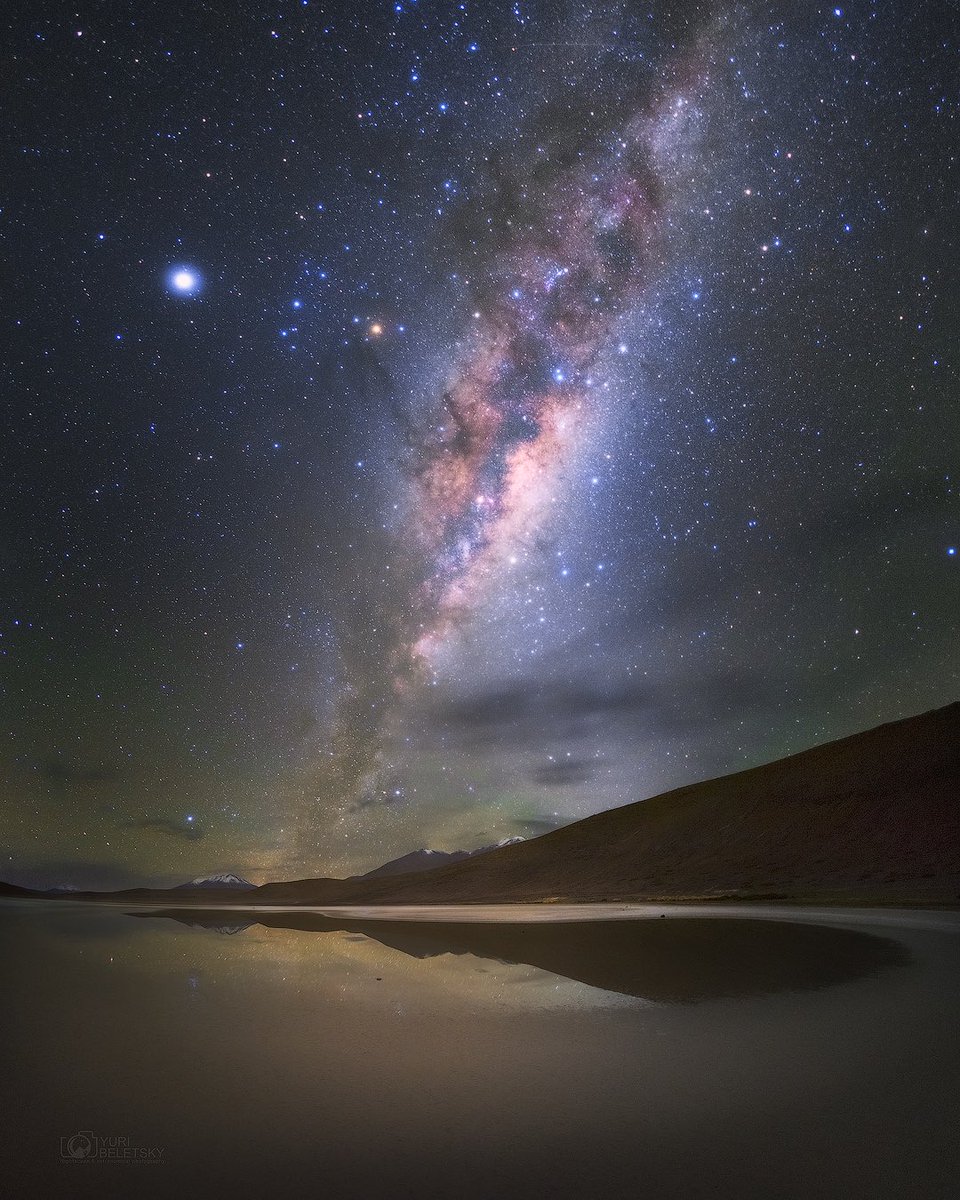 YBeletsky's tweet photo. I captured this image on the high-altitude plains (~15000 ft) in Bolivia as the Milky Way was rising above a small pond in the desert. What a serene scene ! The cold weather and lack of oxygen made it challenging, but the experience was unforgettable 😅 https://t.co/xwxnI7phRp