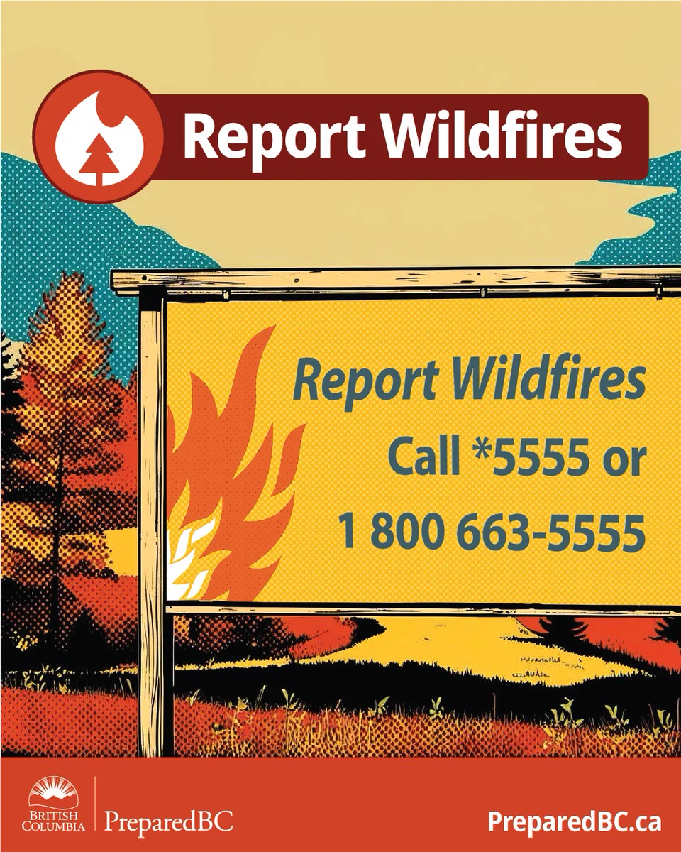 A roadside sign with wildfire reporting number in a rural landscape with trees and hills.