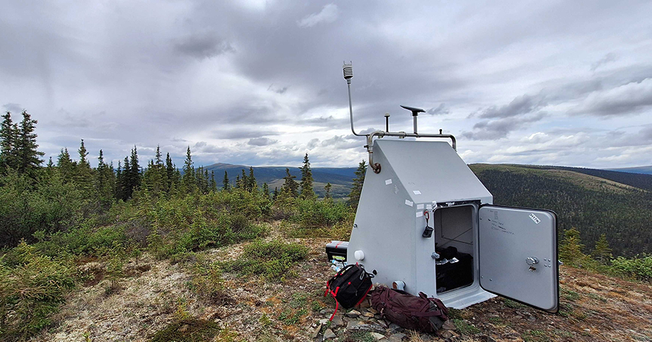 AKearthquake's tweet photo. It’s #FieldworkFriday! Under the midnight sun,☀️ our field team manager Carolyn Parcheta and undergraduate intern Devin Zigmont worked out of Kotzebue, on Alaska’s western shore (yes, that’s sea ice visible on the horizon!). 🧊 Station H17K had a run-in with a critter…scratch marks on the door were too small for a bear, maybe a wolverine? The culprit yanked cabling out of the seismometer borehole until it found a bag full of soft stuffing that insulated the instrument from surface noise. The field team found the bag shredded and fluff scattered across the site. In addition to cleaning up and repairing the cables, they also added a satellite antenna upgrade and scouted the site for potential future placement of GNSS (high-accuracy GPS) instruments.