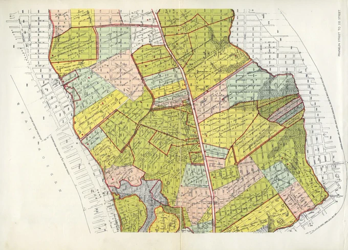 Detailed vintage map showing various colored land plots and street grids in a city section with labeled roads and boundaries.