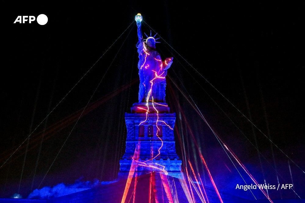 AFP's tweet photo. Techno music and lasers brought the Statue of Liberty to life as a light show at the iconic monument will be broadcast Friday to mark the United States' 250th anniversary https://t.co/J8kdwzIbyx https://t.co/v4Fp8hrjDn