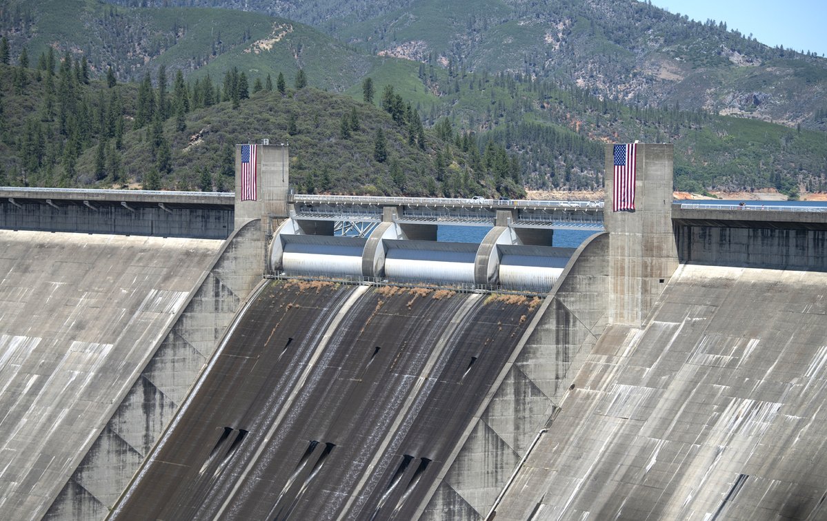 usbr's tweet photo. A symbol of celebration is rising over Shasta Dam! 🇺🇸

Recently, crews installed two large 20-by-30-foot American flags on the towers at Shasta Dam, setting the stage for this weekend’s Freedom250 festivities.

The massive flags will stand as proud beacons overlooking the dam as we come together today and tomorrow to honor community, history and the spirit of America’s 250th birthday.

📸 1: Maintenance workers at the Northern California Area Office install one of two large flags on a maintenance tower at Shasta Dam.

📸 2: Each tower at Shasta Dam now displays a 20-by-30-foot American flag.

#Freedom250 #Reclamation