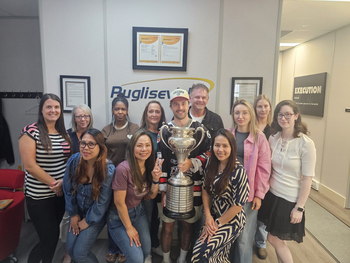 PCSLNL's tweet photo. The Clarenville Caribous won the 2026 Allan Cup! One of the players on the team Tanner Humber-Dredge stopped by our office today with the cup to show it off and of course we took a group photo as Puglisevich was a proud sponsor! Way to go by’s! Congratulations on the big win! https://t.co/yQNZW0O9jn