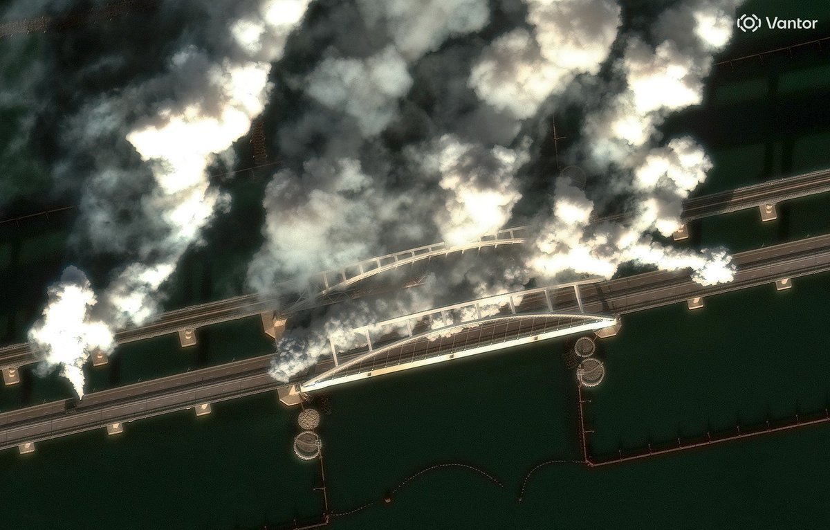 World_At_War_6's tweet photo. 🇷🇺Russia is fighting Ukrainian drone swarms over the Kerch Bridge with WWII smoke screens.

In recent weeks, defending Crimea and the strategically vital Kerch Bridge has become increasingly difficult for Russia. 

Despite advanced air defenses like the S-400 and Pantsir, drone swarms keep breaking through.

Putin has ordered every available resource to protect the bridge-  including old diesel-powered smoke generators. These pump out thick gray clouds that shroud the structure, blinding drone optical sensors. 

This is not the first time that World War II-era weapon systems have been used in the Russia-Ukraine conflict. 

📌Satellite image © 2026 Vantor